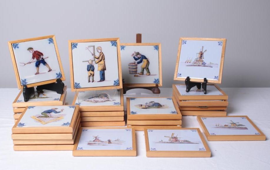Collection of 25 Westraven Anno Tiles: Marked Westraven Anno 1661 Holland with a variety of subject matter, wind mills, and genre subjects depicting traditional professions. All are same size framed in blonde wood with hangers. Dimensions