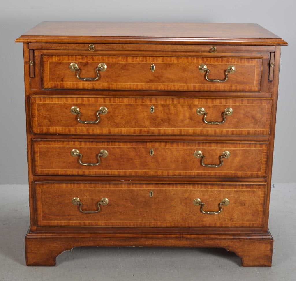 George III Style Bachelors Chest: With a moulded rectangular top over a slide out shelf over four graduated and banded full drawers, raised on bracket feet Dimensions: H 31 x W 33 x D 18 inches NOTE: Wear consistent with age and use