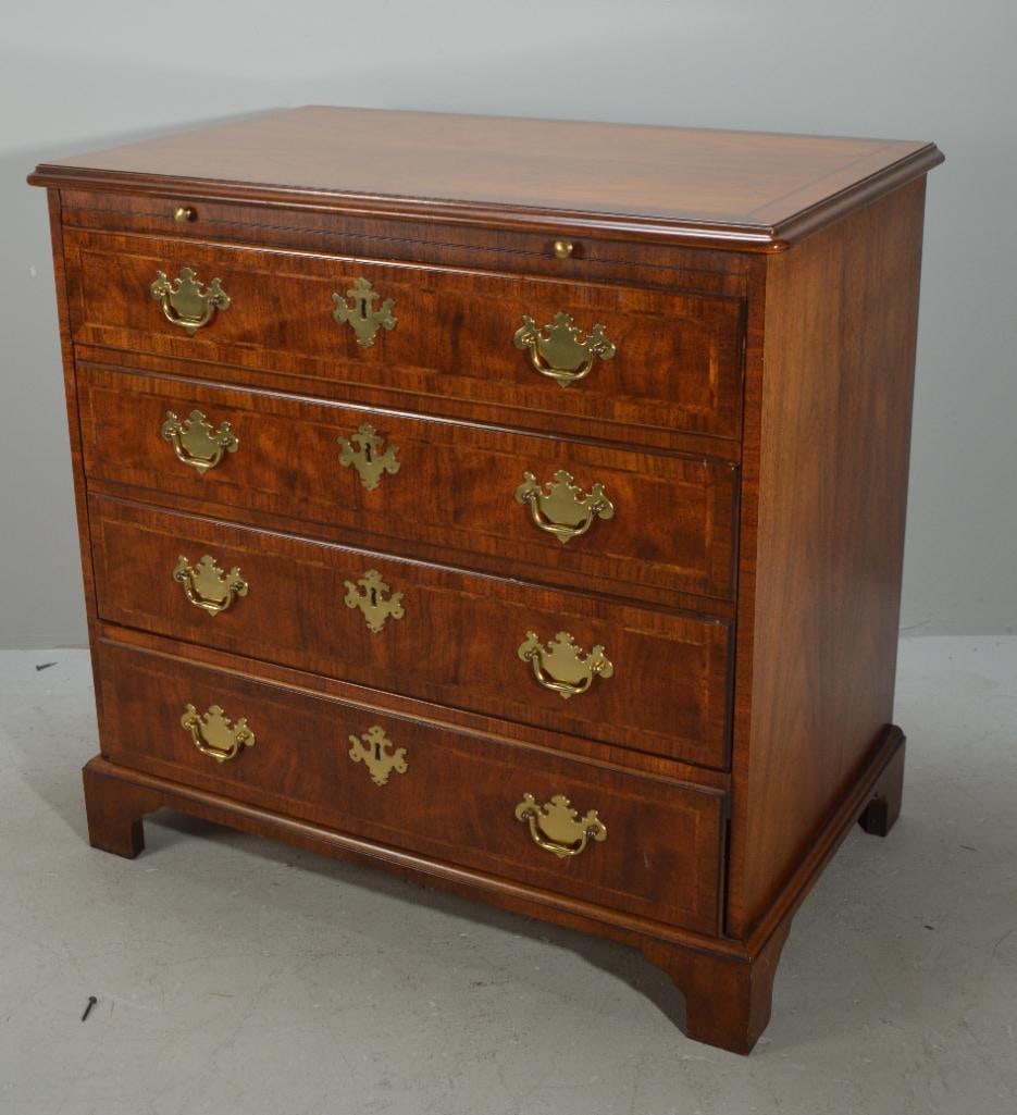 George III Style Bachelors TV Chest: With a moulded rectangular top over a slide out shelf over four faux graduated and banded full drawers that slide up to reveal a tv cabinet, raised on bracket feet Dimensions: H 31 x W 33 x D 18 inch