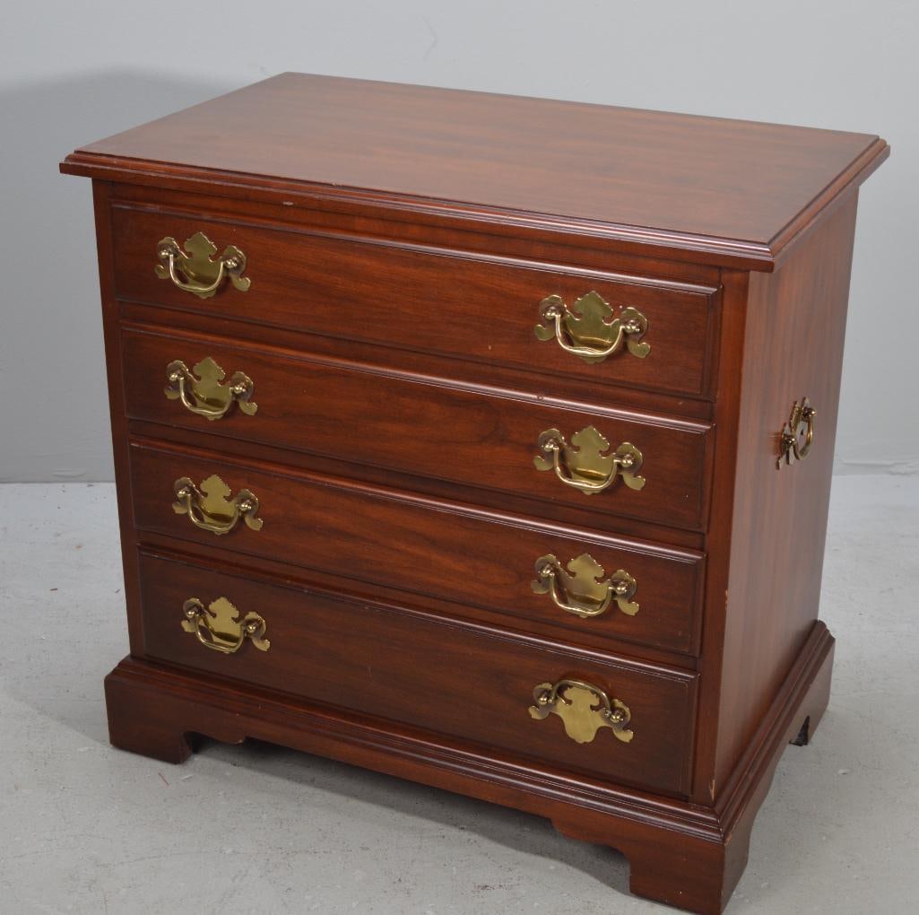 George III Style Bachelors Chest: With a moulded rectangular top over a slide out shelf over four graduated and banded full drawers, raised on bracket feet. Made by Henkel-Harris Dimensions: H 31 x W 33 x D 18 inches NOTE: Wear consis