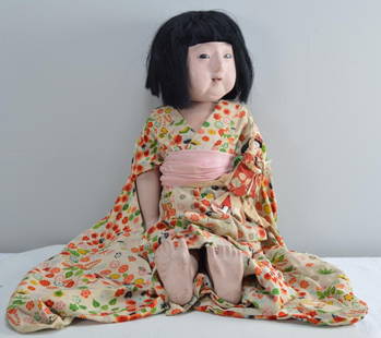 Antique 1920s Japanese Doll: Applied black wig, inserted pupiless eyes, arched brows, closed red mouth with accents, breathing nostrils. Composition body wrapped in o/stamped paper, dislodged legs as is common with the paper