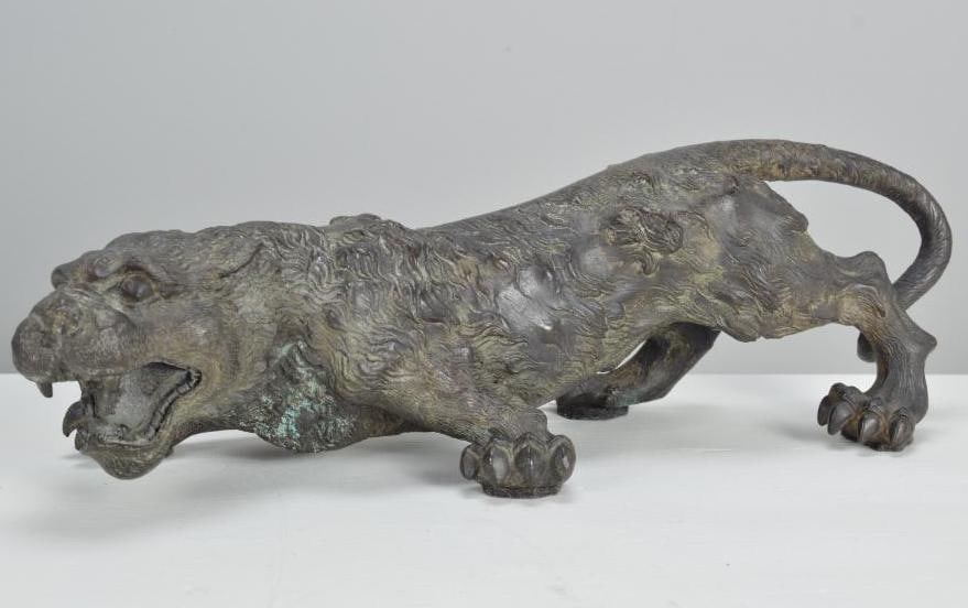 Malayan Cast Iron Tiger: With a verdigris patina, cast iron South Asian tiger, with open mouth and paws Dimensions: H 4.5 x W 14 x D 5 inches NOTE: Good condition given age and use