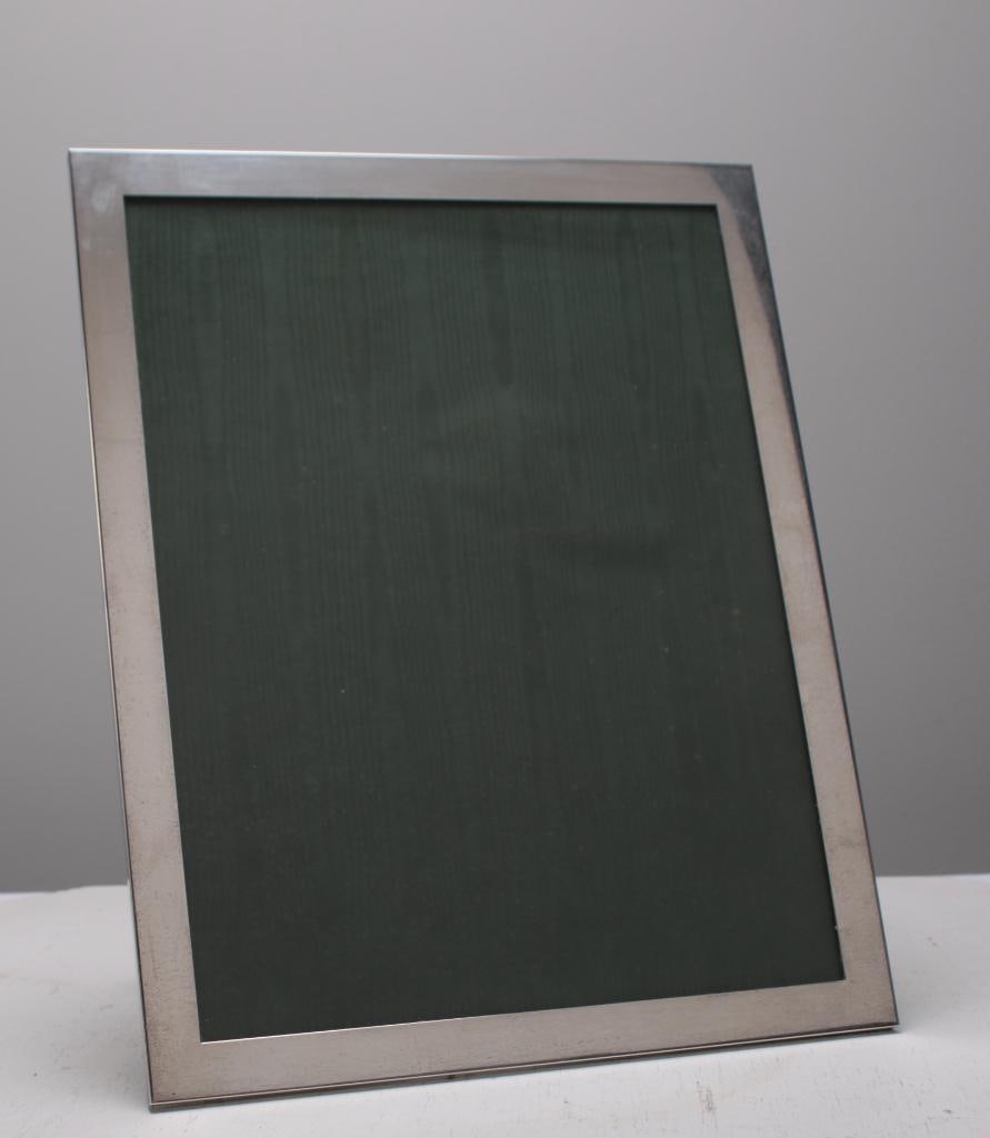 Sterling Silver Picture Frame: With a plain edge, unmarked. Dimensions: H 14 x W 11 x D 0.5 inches NOTE: Wear consistent with age and use