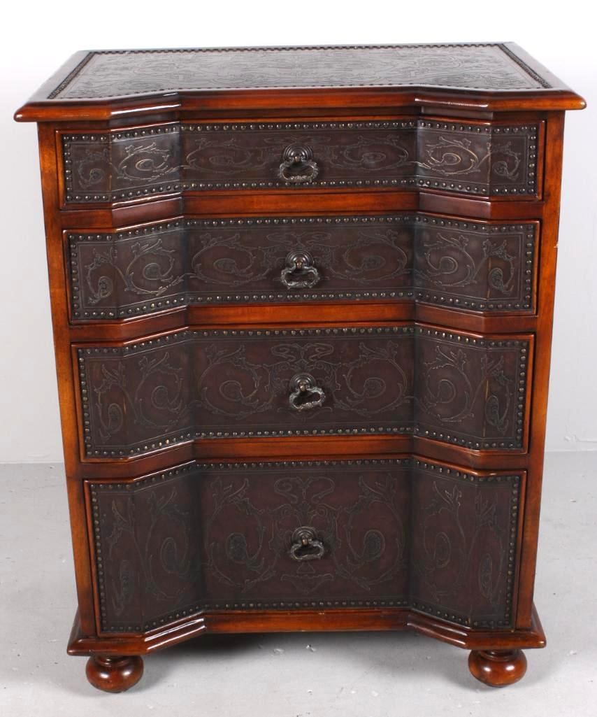 William and Mary Style Bachelors Chest: With a shaped top with an inset chased metal insert, over three shallow and one deep drawer, each with a chased metal panel, the whole raised on bun feet. Dimensions: H 30 x W 24 x D 16 inches NOTE: W