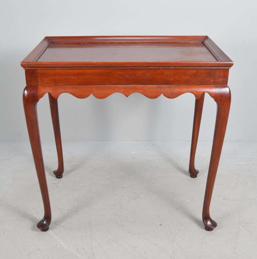 Queen Anne Style Tea Table: With a galleried top, over a shaped apron with candlestick slides, raised on round legs ending in pad feet Dimensions: H 26 x W 28 x D 18 inches NOTE: Wear consistent with age and use