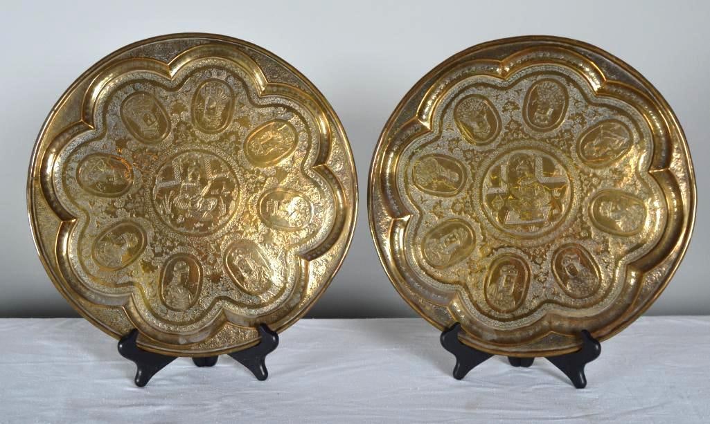 Pair of Brass Persian Trays: Each with a central medallion of a musician, surrounded by 8 escutcheons featuring portraits of Kings (Faridoon, Afrasiyaab, Sanobar etc). Measurements for each. Dimensions: H 1 x W 15.5 x D 15.5 inch