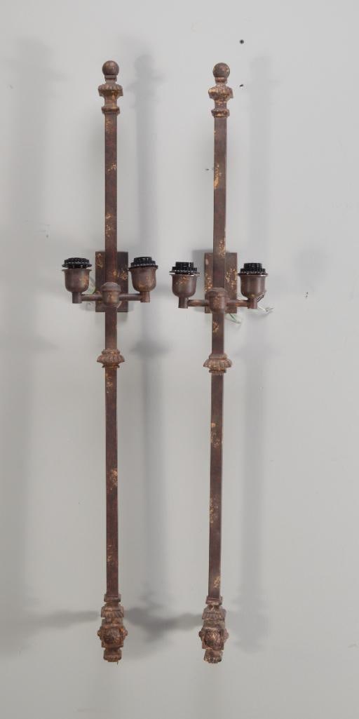 Pair of Patinated Two Light Sconces: Each with a central square post surmounted by a ball finial Dimensions: H 45 x W 7 x D 6 inches NOTE: Wear consistent with age and use
