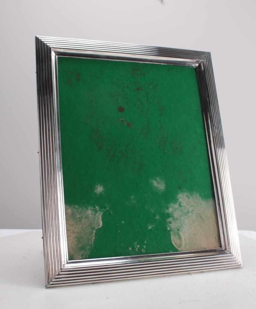 Sterling Silver Picture Frame: With reeded edge, unmarked. Dimensions: H 17 x W 14 x D 1 inches NOTE: Wear consistent with age and use