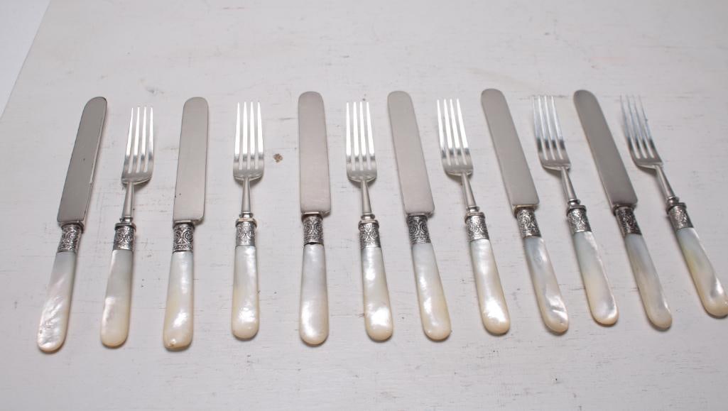 J Russell and Co Luncheon Setting for 5: Including 5 forks and 5 knives, all with mother of pearl handles. Marked on blade, knife is 8in. NOTE: Wear consistent with age and use.