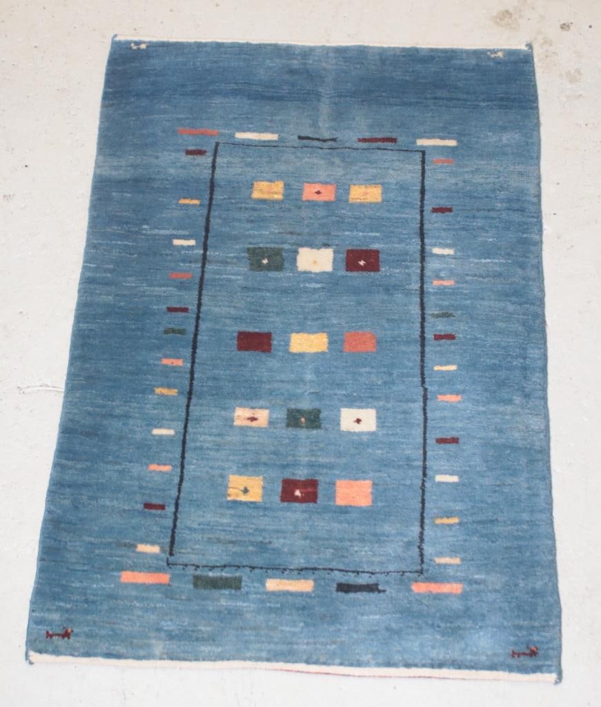 Tribal 3' 11" X 2' 6" Gabbeh Rug: Hand woven wool with geometric forms on blue ground.Dimensions: H 1 x W 47 x D 30.5 inchesNOTE: Good Condition