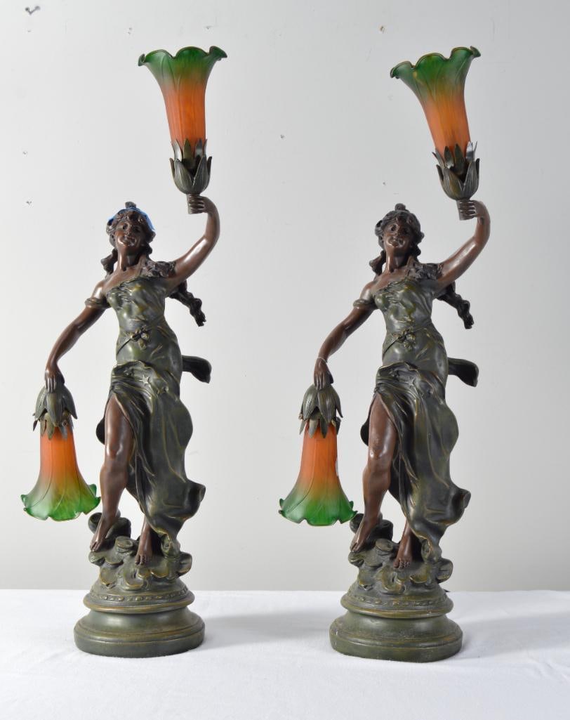 After Auguste Moreau (French, 1834-1917): Pair of Lady Liberty figural lamps. Dimensions: H 27 x W 9 x D 9 inchesNOTE: Damage to one arm