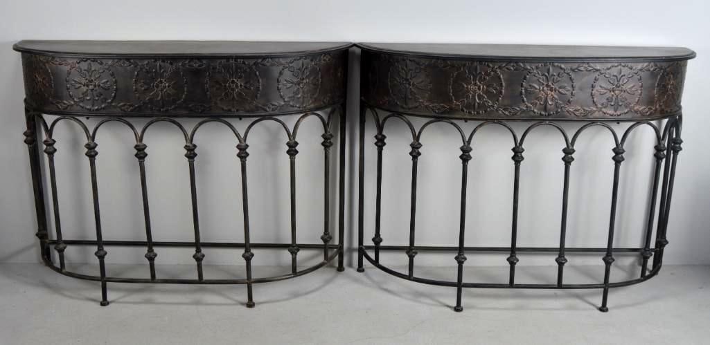 Pair of Metal Pier Tables: Of demilune form, with embossed apron, raised on four legs with spindles between Dimensions: H 35 x W 49 x D 17 inches NOTE: Wear consistent with age and use Property from an Anchorage, KY home