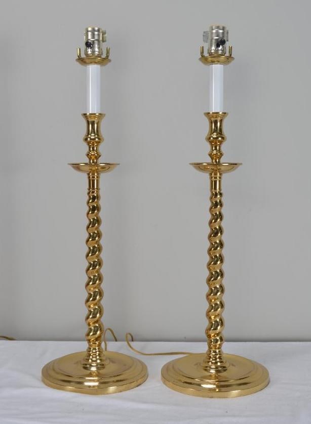 Pair of Barley Twist Brass Lamps: Each with a faux candle over a barley twist column, raised on a shaped round base. Dimensions: H 27 x W 8 x D 8 inches NOTE: Good condition Property from an Anchorage, KY home