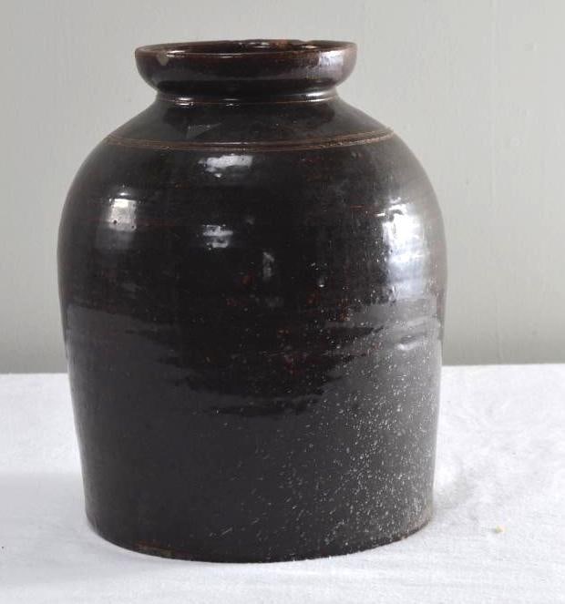 Brown Ground Pottery Jar: With a flared lip and rounded and incised shoulder. Dimensions: H 12 x W 9 x D 9 inches NOTE: no evidence of chips, cracks or repairs Property from an Anchorage, KY home