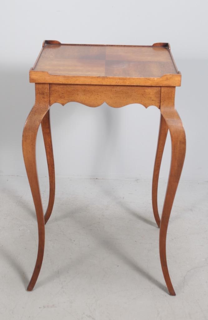 Louis XV Style Side Table: With a galleried top over a shaped apron, raised on four cabriole legs Dimensions: H 26 x W 15 x D 15 inches NOTE: Some fading to top