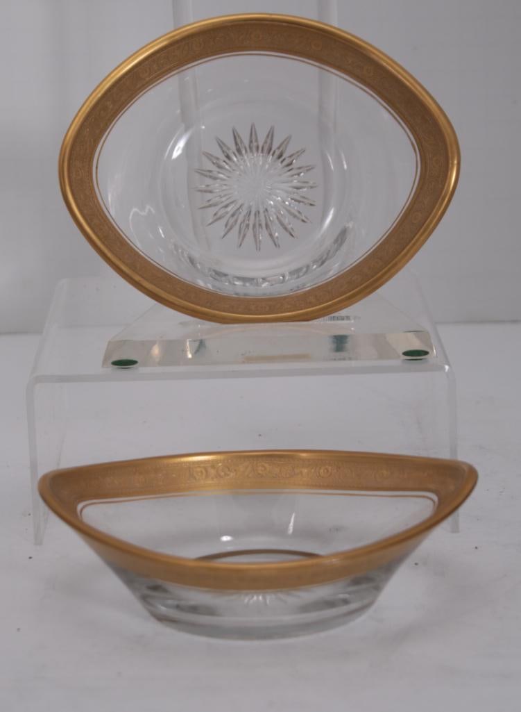 Pair of Cut Glass and Gilt Nut Dishes: Each with cut glass base and parcel gilt rim, Marked with Heisey Glass marks Dimensions: H 2 x W 6 x D 4.5 inchesNOTE: No evidence of chips or cracks