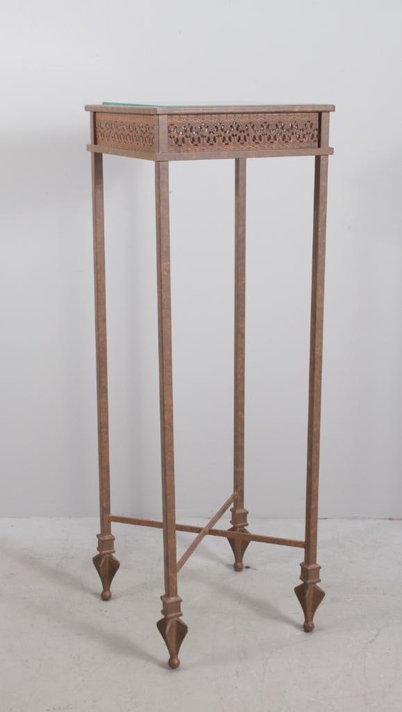 Metal Plant Stand: With insert glass top over a pierced frieze, raised on four square legs ending in arrowhead feet supported by an X-stretcher Dimensions: H 42 x W 14 x D 14 inches NOTE: Wear consistent with age and us