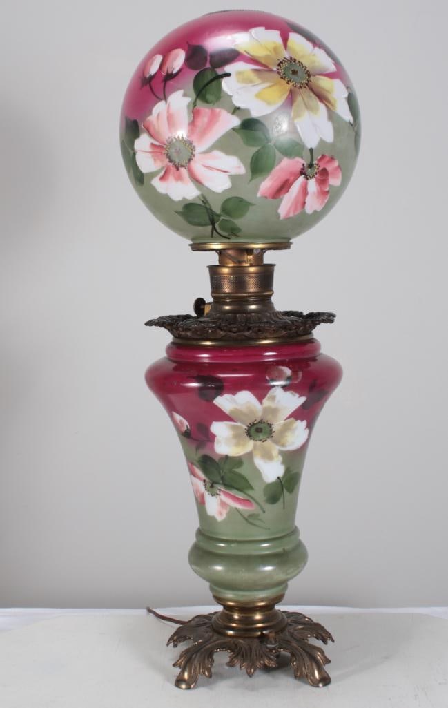 Rose Floral Lamp: With a painted ball shade over a painted body, raised on acanthus feet Dimensions: H 31 x W 8.5 x D 8.5 inches NOTE: Wear consistent with age and use. Not tested.