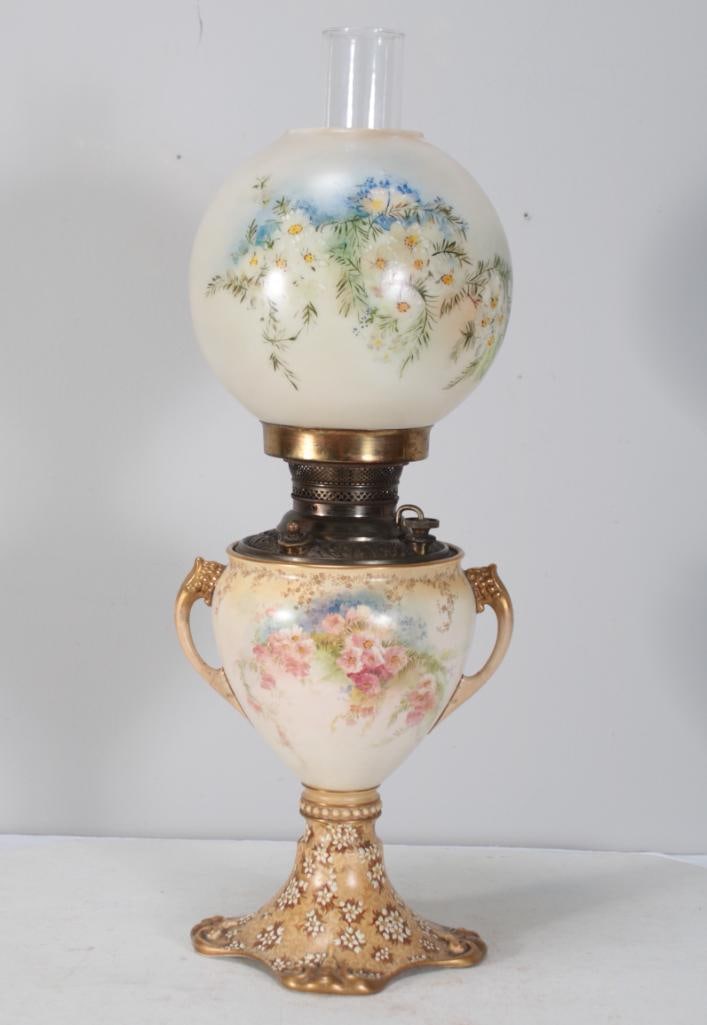 Eastlake Painted Lamp: With a painted glass shade over a painted urn form body, raised on a moulded foot.Dimensions: H 24 x W 8 x D 8 inchesNOTE: Cord is cut. Not tested