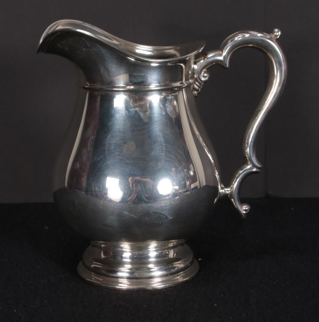 Sterling Silver Water Pitcher: Marked International, 10117-1, 4 1/4 pts. Approx. 700 grams. Dimensions: H 8.75 x W 8.75 x D 5 inches NOTE: Good
