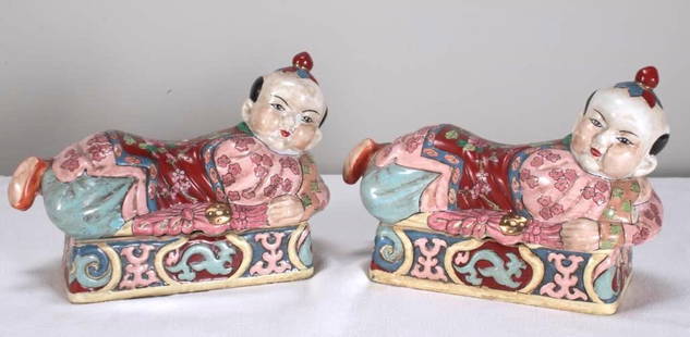 Pair of Famille Rose Figural Porcelain Pillow Boxes, marked Jiaqing: Each of a man supine, opening to reveal storage, each marked underneathDimensions: H 8.5 x W 12 x D 5 inchesNOTE: One with evidence of a repair and a small remaining hole