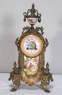 Brass Mantle Clock: With a porcelain urn finial over a painted porcelain arabic face, the body with a porcelain plaque presenting a courtship scene. Works marked &#34;Made in France&#34;  Dimensions: H 17 x W 9 x D 6 inc
