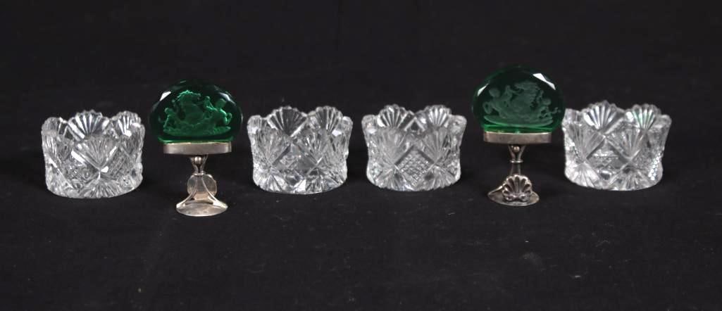 Four (4) Cut Glass Salts: Together with two etched green glass place card holders Dimensions: H 1 x W 1.75 x D 1.75 inches NOTE: Good Condition