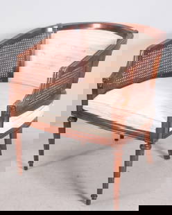 Regency Style Armchair: With a shaped back and arms with rattan, the upholstered seat and back over a plain frieze, raised on fluted and turned legs. Dimensions: H 30 x W 25.5 x D 26 inches NOTE: Wear consistent with