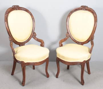 Pair of Renaissance Revival Side Chairs: Each with a round upholstered back surrounded by carved rails, the upholstered seat over a carved apron, raised on carved cabriole legs. Dimensions: H 38 x W 18 x D 23 inches NOTE: