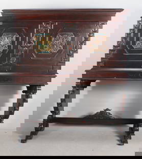 Spanish Colonial Style Secretary: WIth a square top over a drop down writing surface adorned with lozenges of mythical beings opening to reveal twelve cubbies and two drawers, raised on carved plank legs supported by a stretcher.