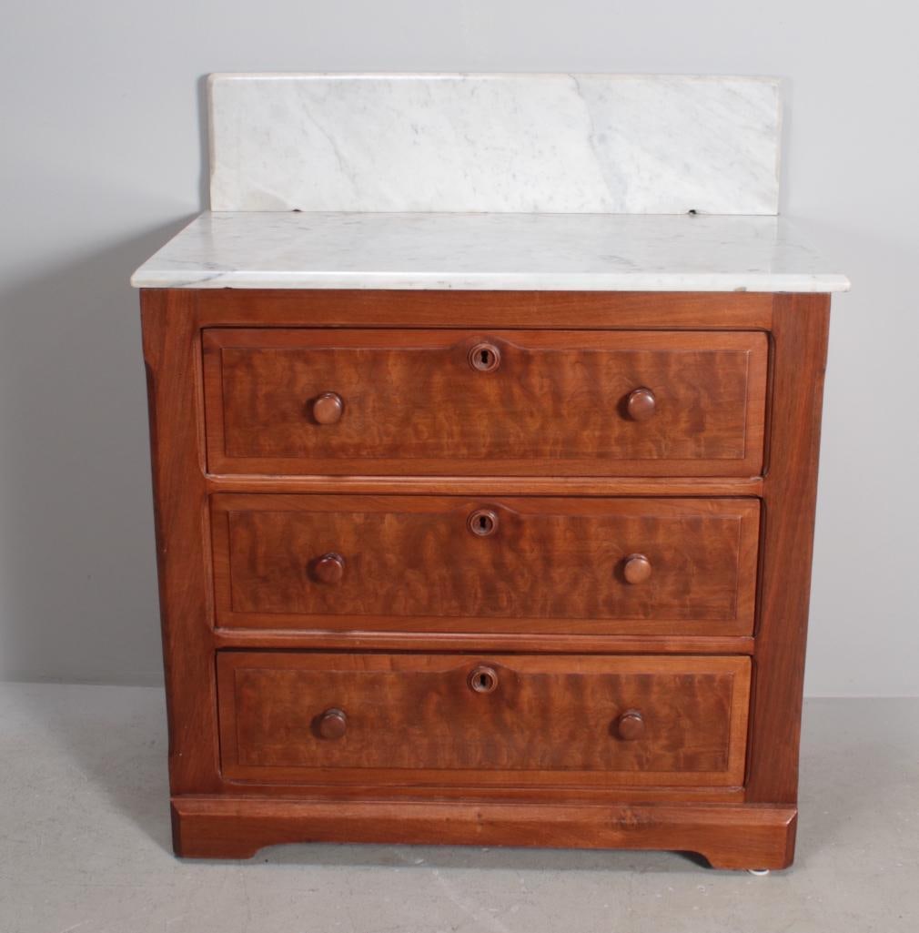 Eastlake Walnut Chest of Drawers: With a moulded marble top and backsplash over three banded drawers, raised on a plain plinth. Dimensions: H 28 x W 30 x D 17 inches NOTE: