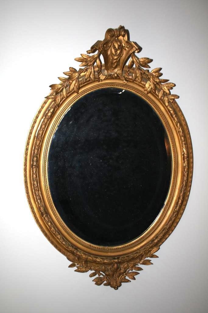 George III Style Giltwood Mirror: With an acanthus and olive leaf pediment over a beveled circular glass Dimensions: H 44 x W 30 x D inches NOTE: Good