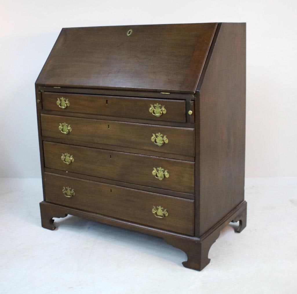 George III Style Secretary: With a rectangular top over a drop down desk opening to reveal cubbies over four drawers, raised on bracket feet Dimensions: H 42 x W 37 x D 21 inches NOTE: Good