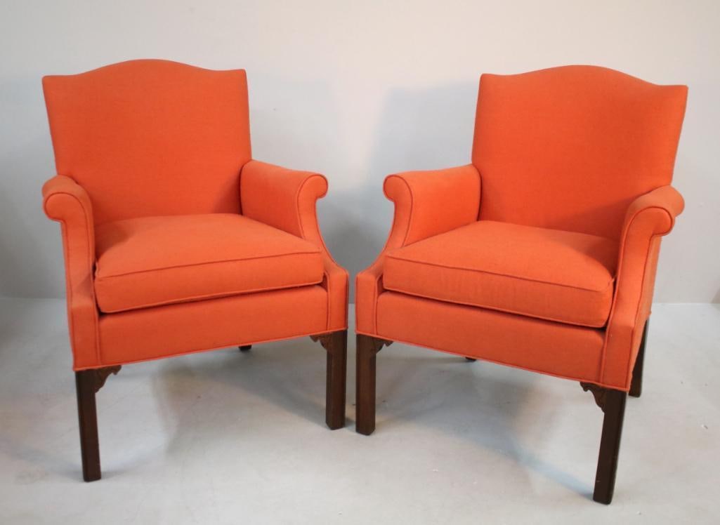 Pair of George III Library Chairs: Fully upholstered with orange/red or salmon colored fabric, shaped crestrail over scrolling arms, raised on carved square legs Dimensions: H 36 x W 27.5 x D 29 inches NOTE: Good