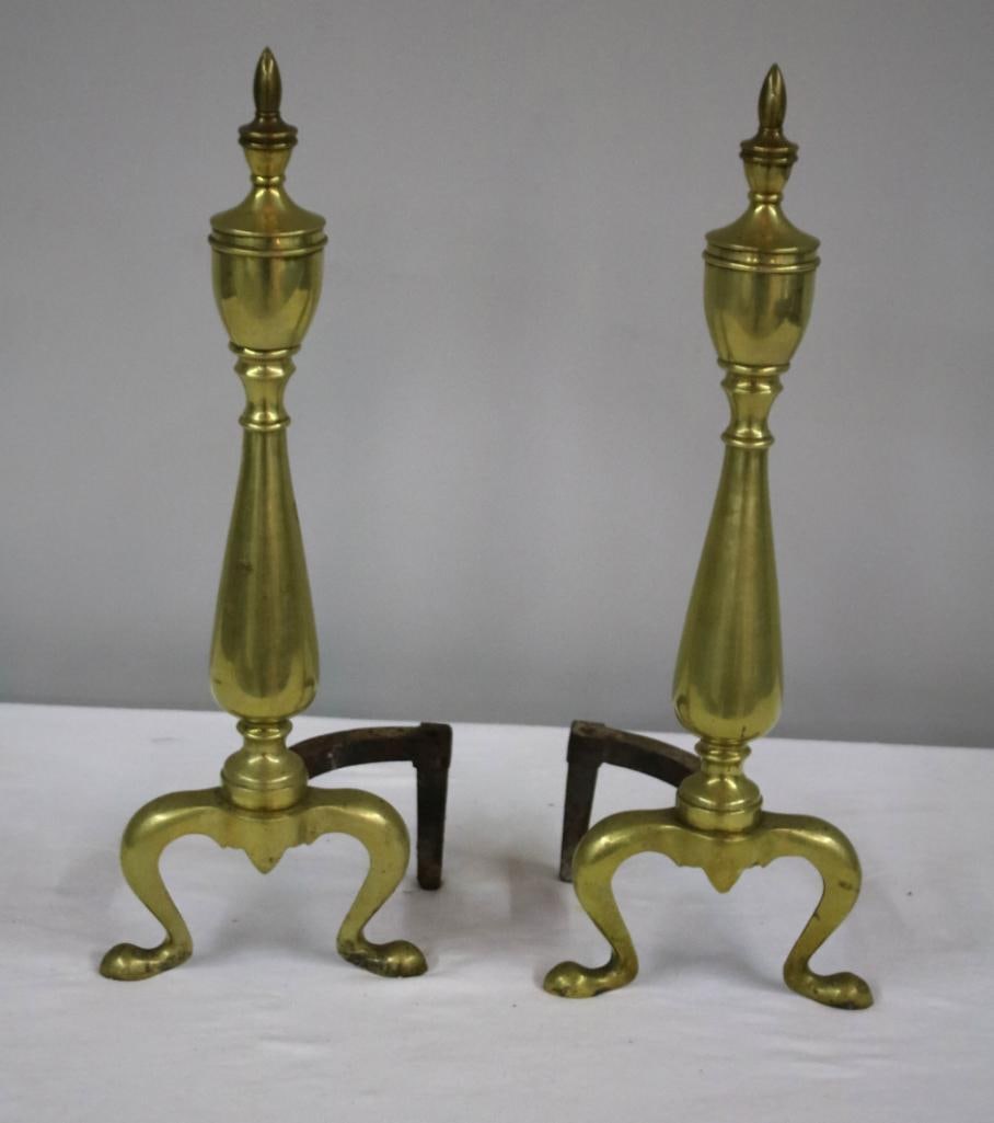 Pair of Brass Andirons: by Royal. Urn shaped with animal feet. Dimensions: H 21.5 x W 5.5 x D 5.5 inchesNOTE: Good