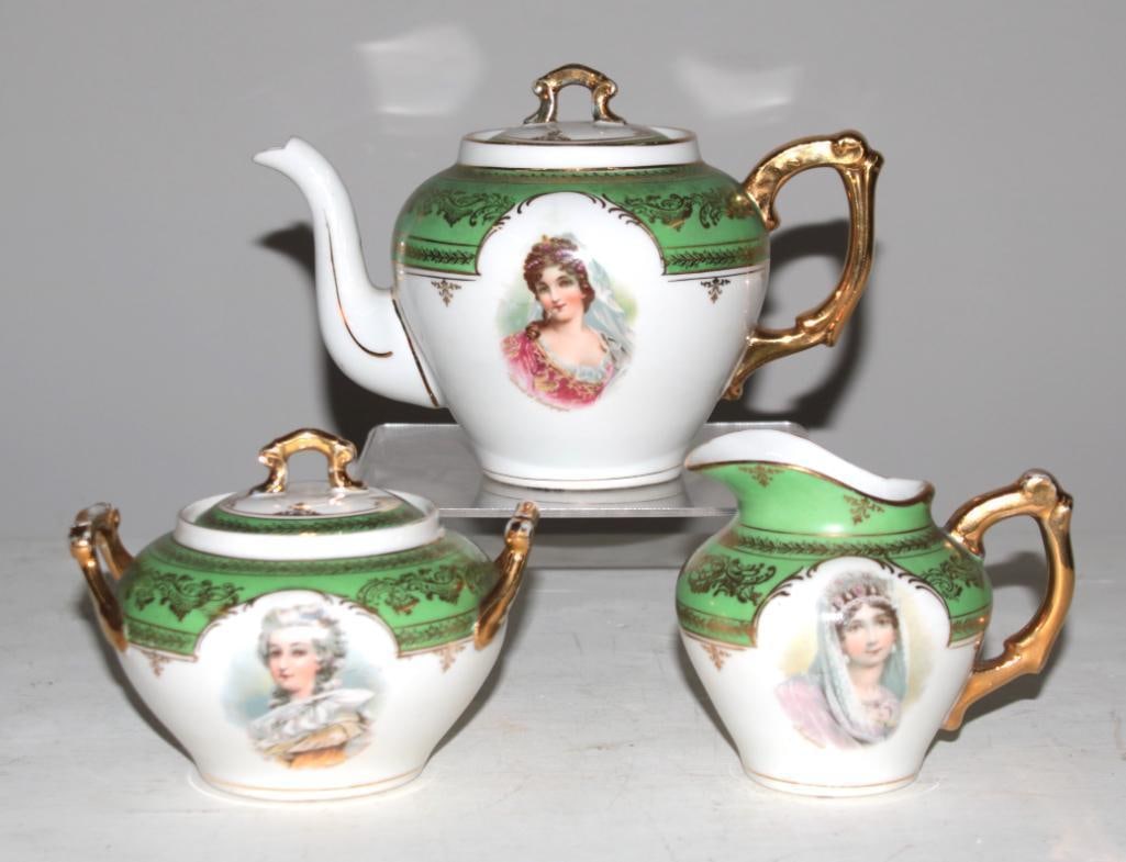 Carlsbad Tea Set: Three pieces, each with gilt knop and handle, with lozenge portrait of exotic women Dimensions: H 5 x W 5 x D 4 inches NOTE: Good