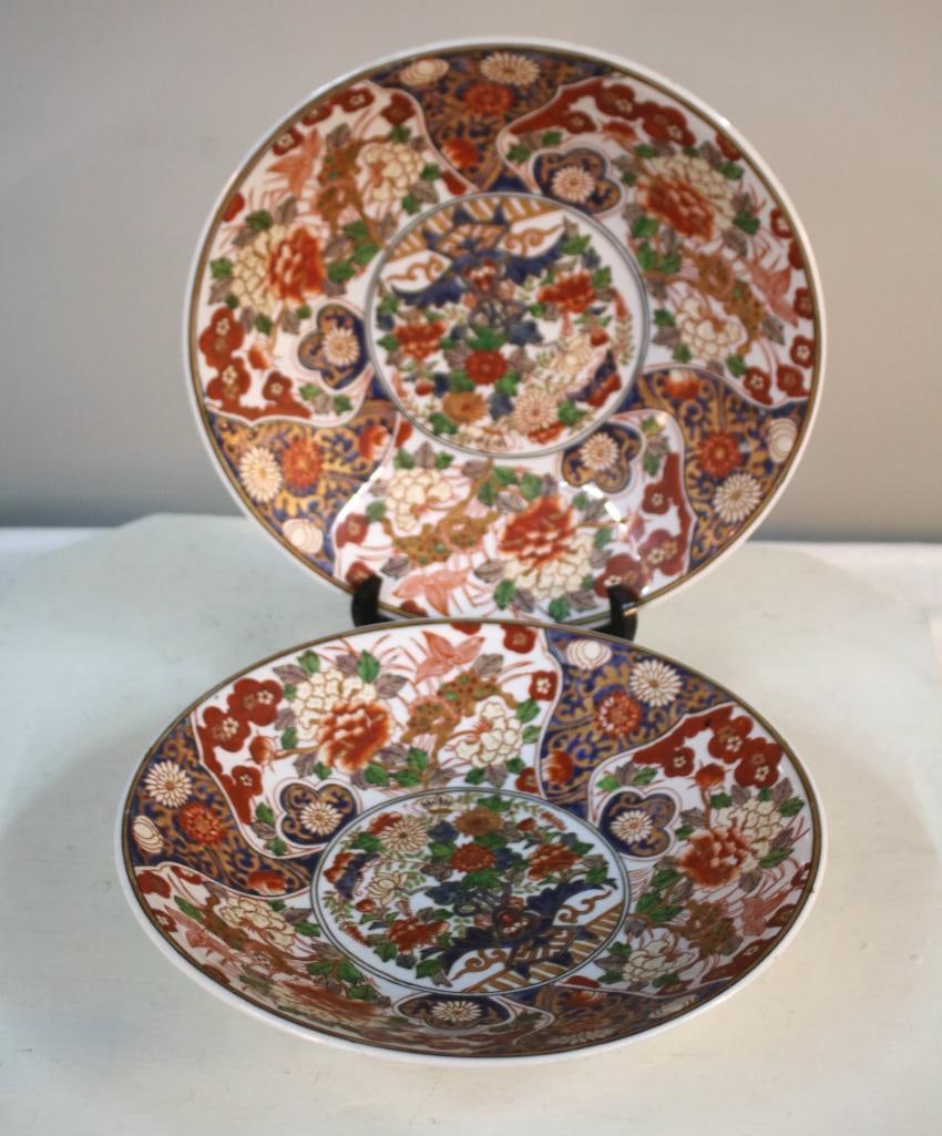Pair of Shallow Imari Bowls: Of usual design, white ground with predominantly orange elements Each is 14 in x 14 in.