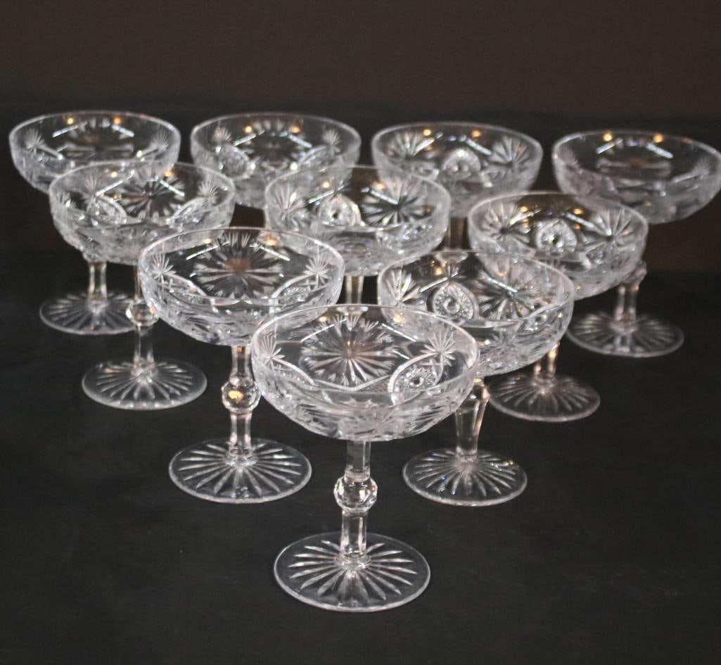 Set of 12 Crystal Coupe Glasses: Pineapple and star cut with a cut ball on stem and fan pattern on base. Not marked, but box in Baccarat box. Dimensions: H 4.5 x W 4 x D 4 inches NOTE: Good