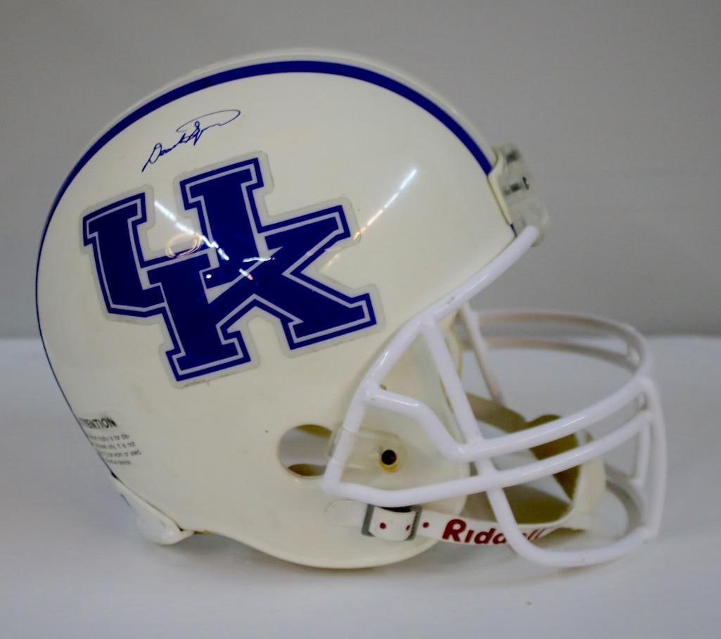 DeAndre Square Signed UK Wildcats Helmet: White Riddell Kentucky Wildcats full-size football helmet with blue center striping and large “UK” decals, signed in blue ink on the shell by linebacker DeAndre Square, retaining the original
