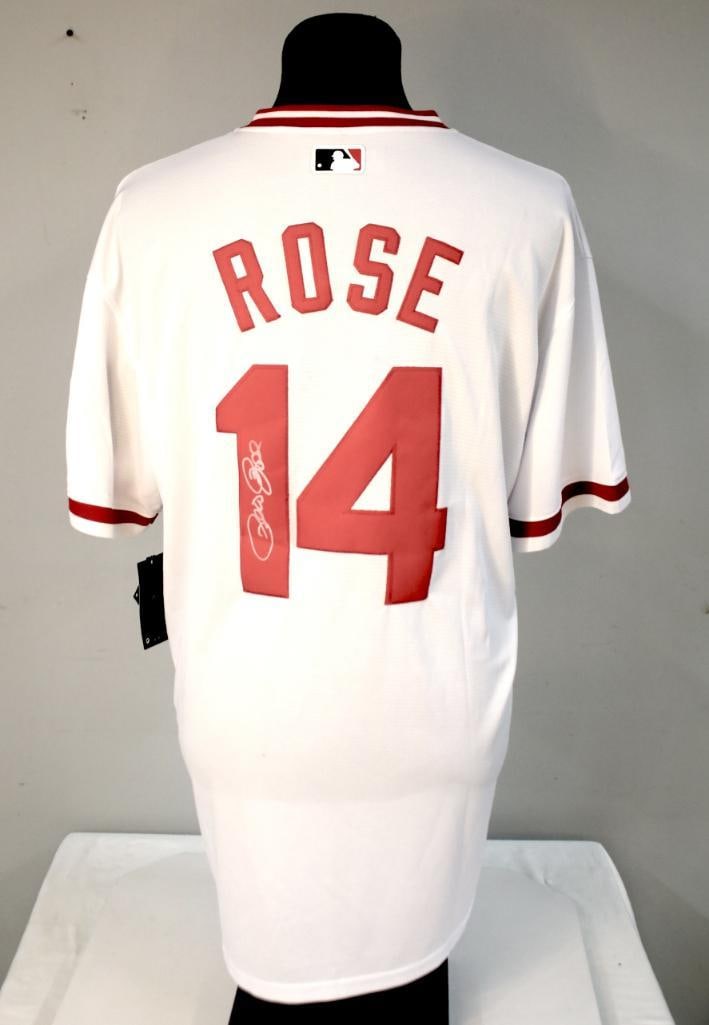 Pete Rose Signed Cincinnati Reds No. 14 Nike MLB Jersey: White Nike MLB Cincinnati Reds baseball jersey, button-front style, featuring red-trimmed collar and sleeve accents, with the reverse lettered “Rose” above number 14. The jersey is signed in s