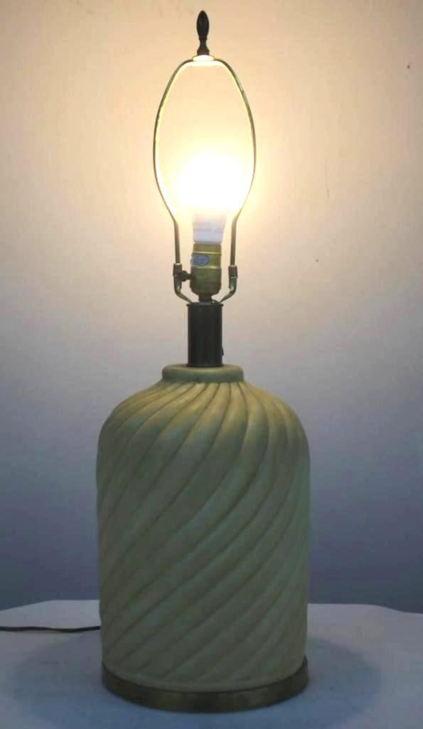 Cream Spiral Fluted Table Lamp: A lamp featuring a cream-colored base with a distinctive spiral or twisted fluted pattern. Dims: 29 x 10 x 10