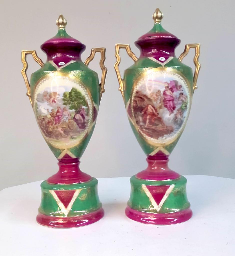 Pair of Hand-Painted Porcelain Urn-Form Vases with Figural Reserves: Pair of decorative porcelain urn-form vases with covers, each featuring twin gilt scroll handles and finial lids. Bodies decorated in a green and magenta ground with gilt accents, centered by oval