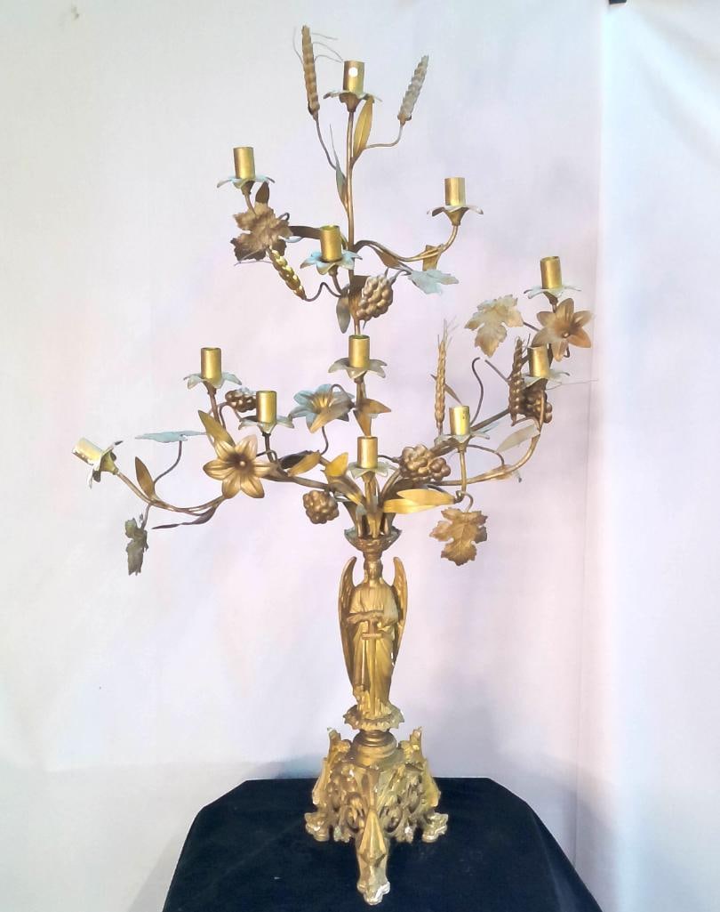 Gilt Metal Figural Grapevine Candelabra: Gilt metal candelabra featuring multi-branch grapevine arms with clusters of fruit and foliage, centered by a standing winged figure and raised on rococo-style bases. Dimensions: H 40 x W 22 x D 12 in