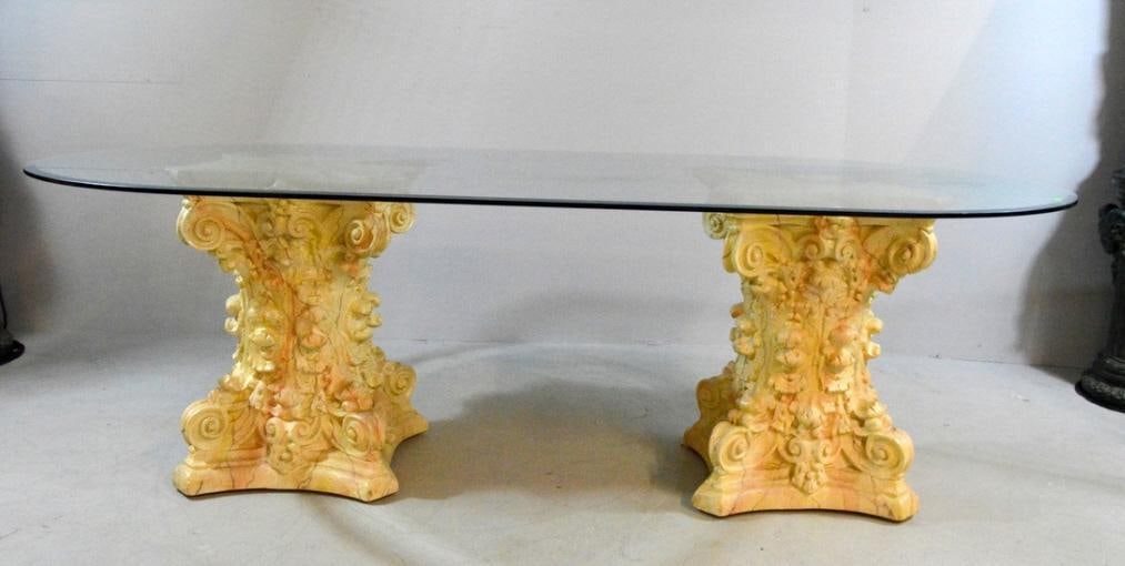 Glass Top Dining Table: Consisting of a rounded rectangular top resting on two columns ornately decorated with acanthus leaves. 30 x 49 x 96 in. Chip to one base.