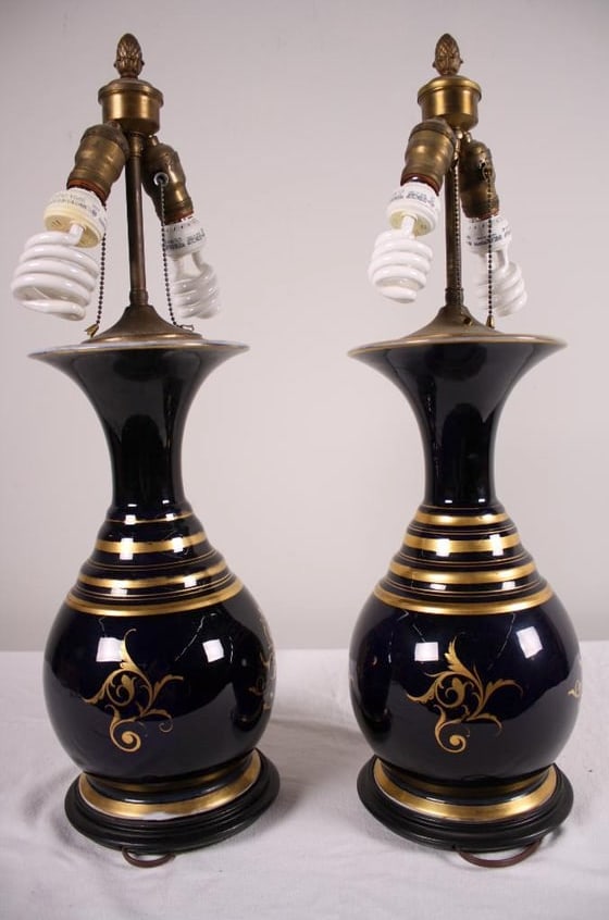 Pair of Paris Porcelain Jars as Lamps: With a cobalt ground and a panel of a bouquet of flowers Dimensions: 27 x 9 x 9 in. NOTE: Both lamps tested and working