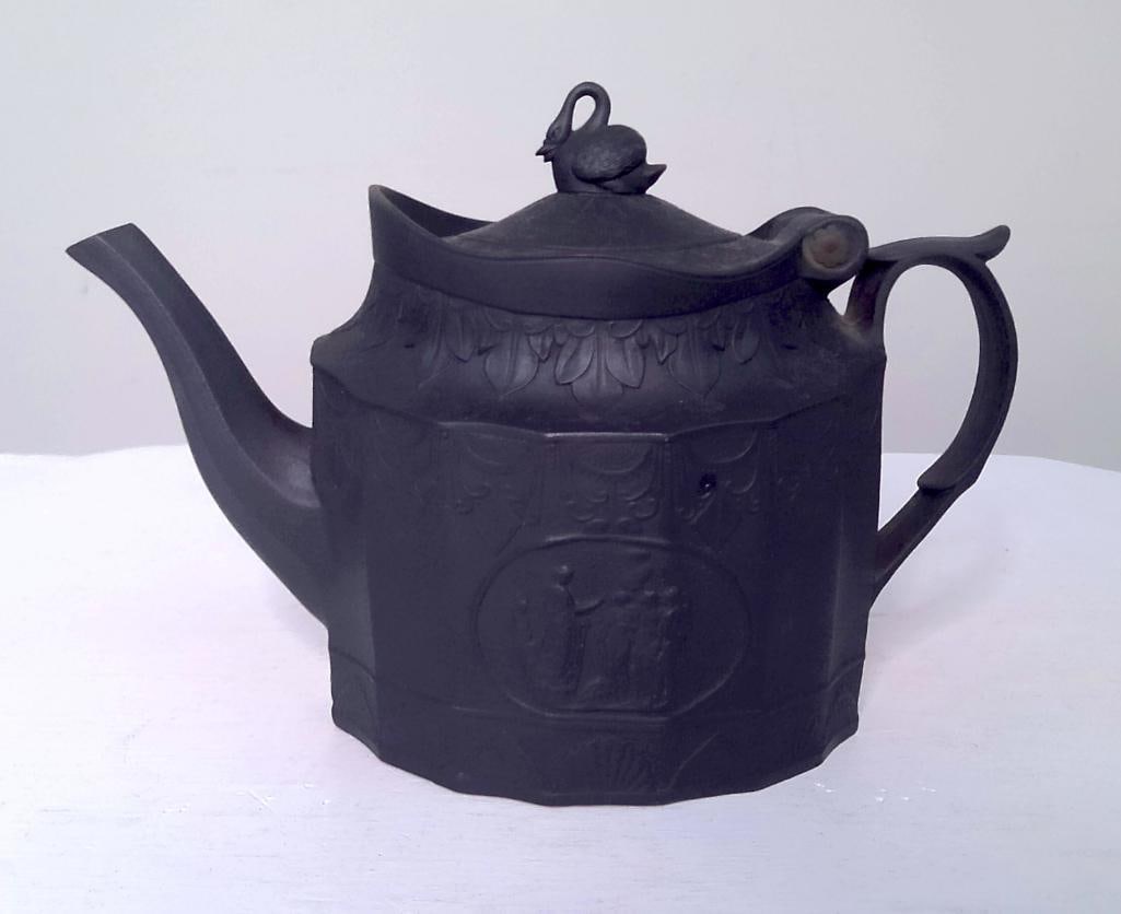 Black Basalt Teapot with Swan Finial: Attributed to William Adams & Co. (Staffordshire, England). Black basalt teapot of faceted octagonal form with molded foliate decoration, shaped rim, and domed cover surmounted by a swan finial. E