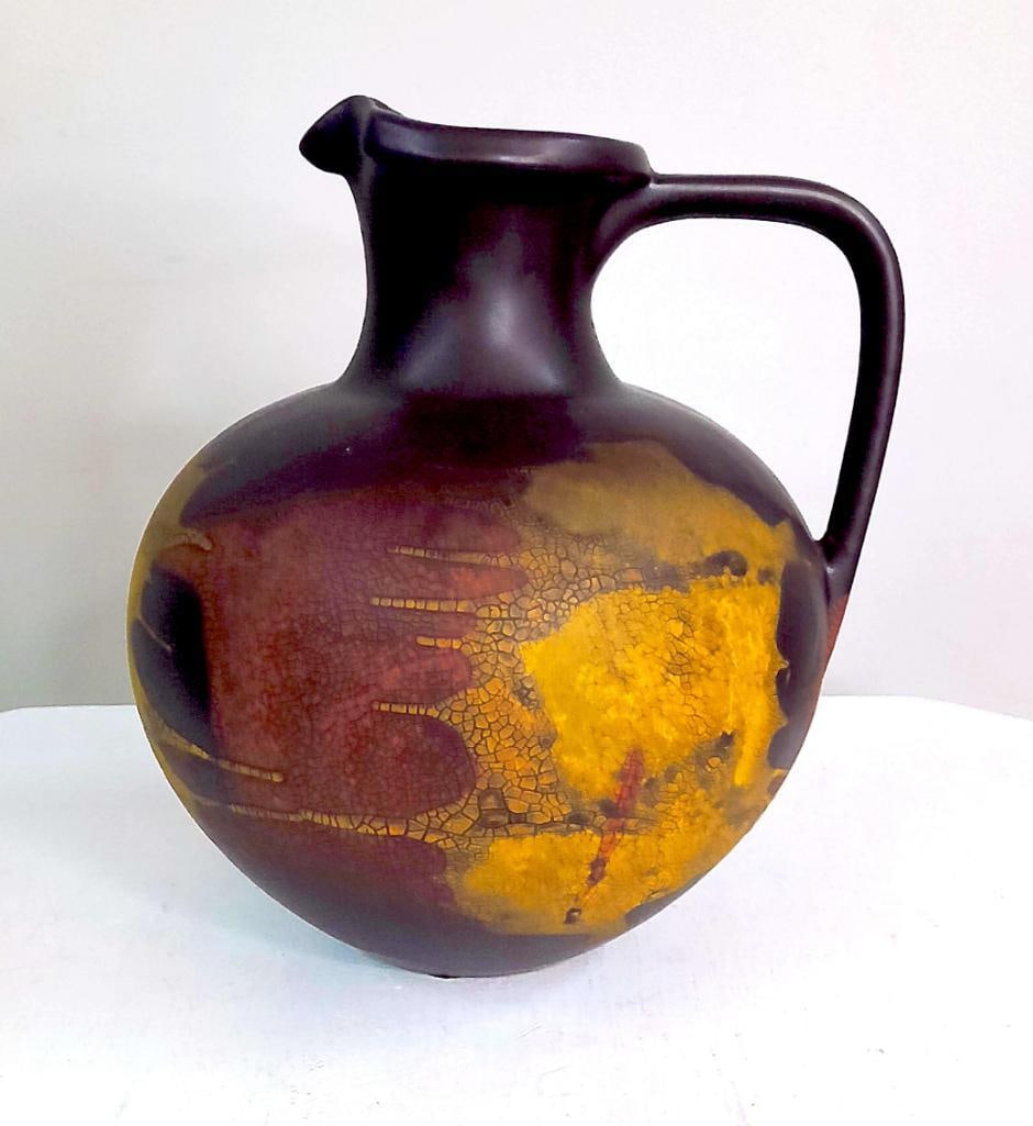 Two Haeger Pottery Metallic Glaze Decorative Articles: Group comprising a Haeger art pottery lamp and matching handled pitcher, each decorated in matte black glaze with metallic gold, copper, and crackle-glazed abstract decoration. The lamp retains a Haeg
