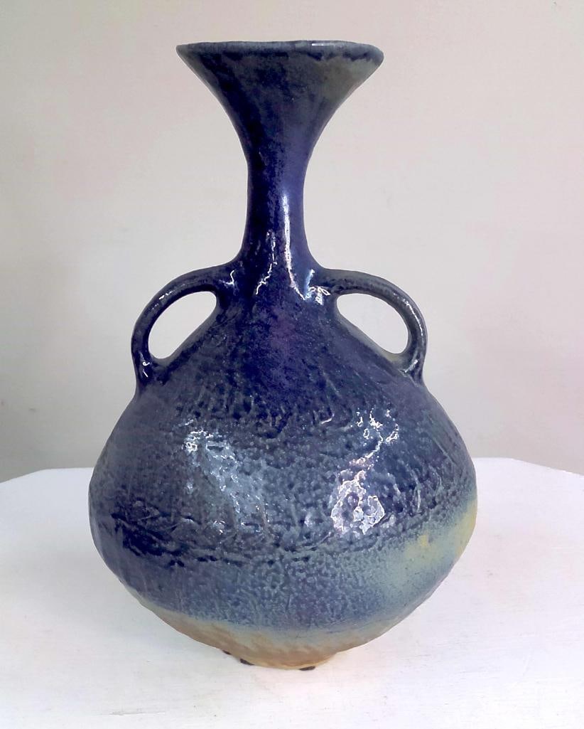 Michael Imes Double-Handled Stoneware Vase: Hand-thrown and hand-finished stoneware vase of globular form with elongated trumpet neck and opposing loop handles, decorated in a mottled cobalt and blue reduction glaze over a buff stoneware body. 