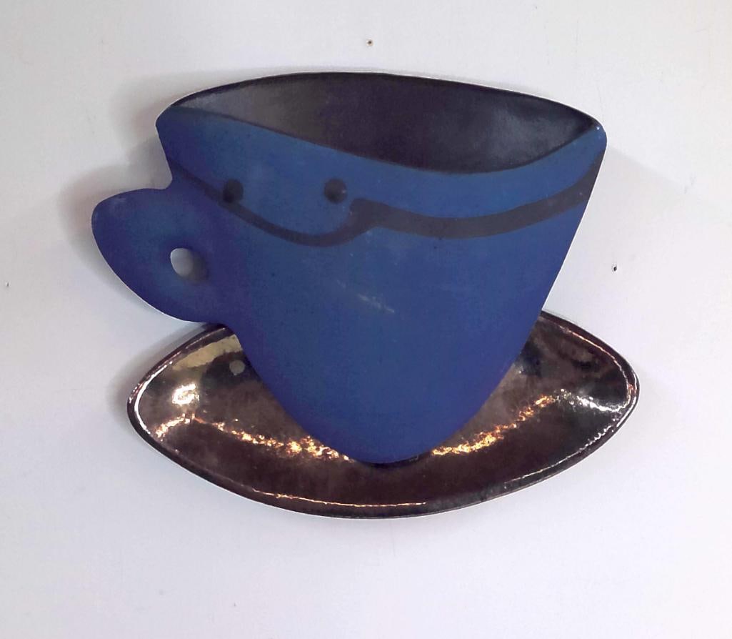 Sarah Fredirick Large Blue Cup Form Ceramic Wall Pocket: Hand-built ceramic wall pocket in the stylized form of an oversized cup and saucer, executed in matte cobalt blue glaze with black linear decoration. The vessel is mounted upon an integrated metallic-