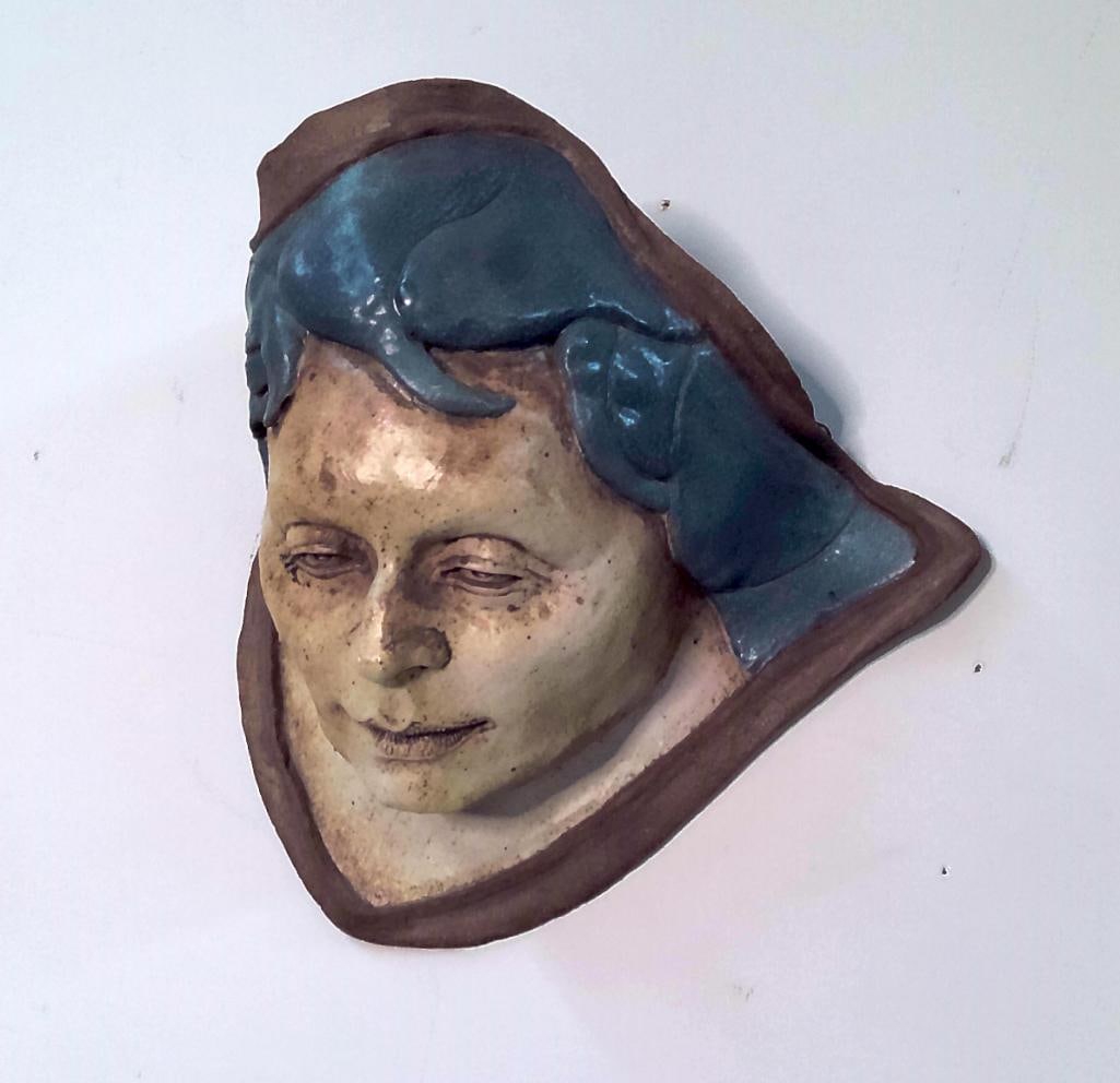 Michael Barnes Ceramic Wall Mask: Hand-built ceramic wall sculpture depicting a stylized female face with blue hair and painted facial features. Signed "Barnes" and dated 8/01 to the reverse. Retains hanging wire. Dimensions: 